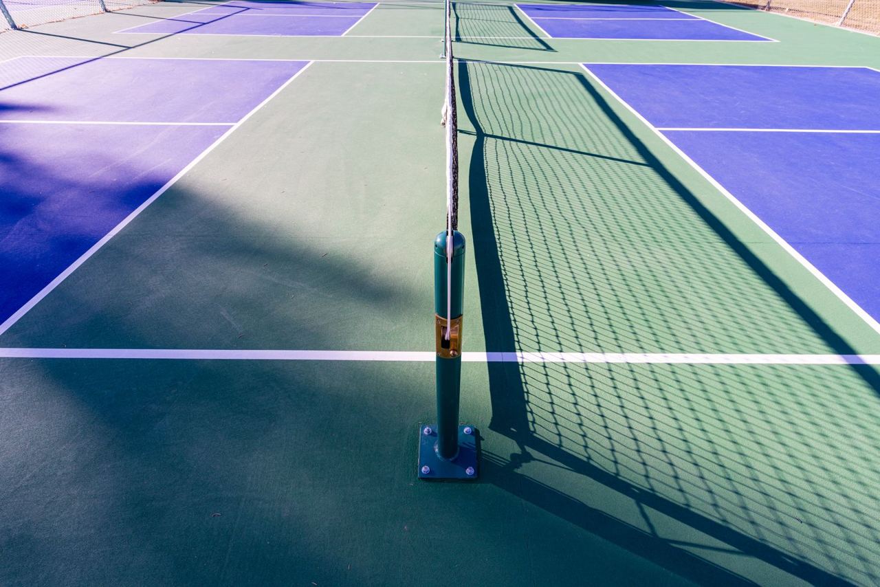 Empty outdoor pickleball courts, shown as an illustrative court photograph